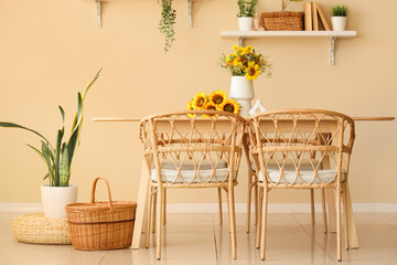 Wild flowers on dining table and chairs in room