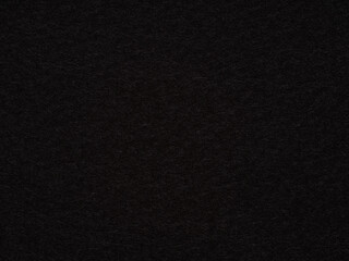 An abyss of onyx, the felt's surface is a silent expanse of darkness, smooth and impenetrable, yet invitingly soft