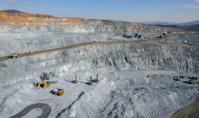 Panoramic of open pit mine industry, aerial view. Big yellow mining truck for coal working in quarry © Parilov