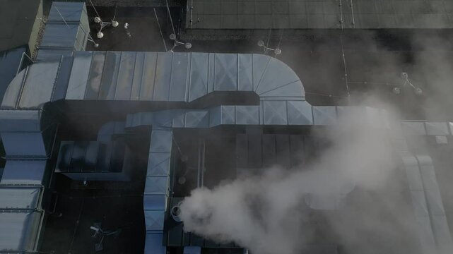 cooling units are industrial or air-conditioning, which are used in the summer for cooling premises, with fans on roof of the storage hall, mainly for industrial operations, high angle view, lawn