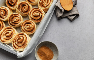 Delicious cinnamon rolls prepared for baking in a rectangular pan