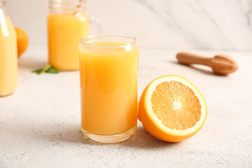 Glass of fresh orange juice on white background