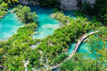 Scenic view Plitvice lakes turquoise waters surrounded by lush greenery rocky cliffs Croatia...