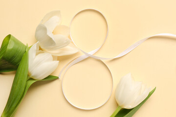Figure 8 made of ribbon and tulip flowers for Women's Day celebration on beige background