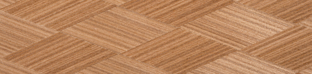 Intricate chevron pattern in natural wood veneer with rich brown hues