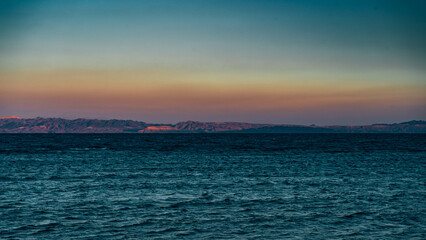 sunset over the beach and mountains