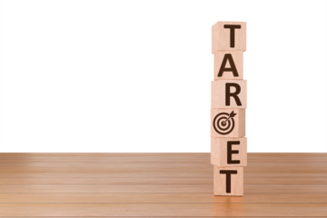 Target Achieved: Wooden blocks spelling out "TARGET" with a bullseye symbol signifying achievement and goal attainment, standing on a light brown wooden surface.