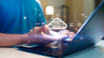 A person holding a glowing cloud icon above a laptop, symbolizing cloud computing, data storage, or...