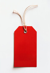 Vibrant Red Tag With Beige String On White Background, perfect for price labels, branding, or personal notes.