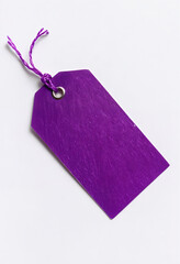 Vibrant Purple Tag With Twisted String Against White Background, perfect for price labels, branding, or personal notes.