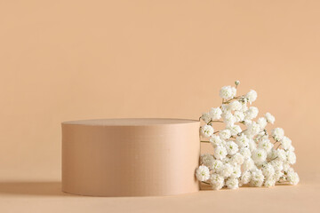 Beautiful gypsophila and plaster podium on beige background