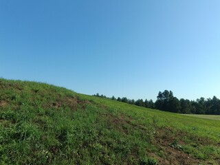 Salduve hill during sunny day. Small hill. Grass is growing on hill. Staircase leading to the top....