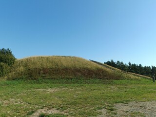 Salduve hill during sunny day. Small hill. Grass is growing on hill. Staircase leading to the top....