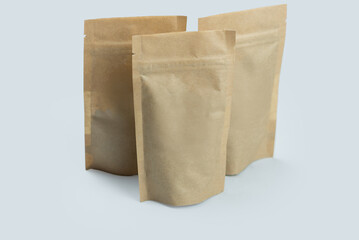 Naklejka premium Coffee packaging mockup, Kraft zip bags for cosmetics, food, mockup bags, eco packaging for handmade products, gray background, isolate