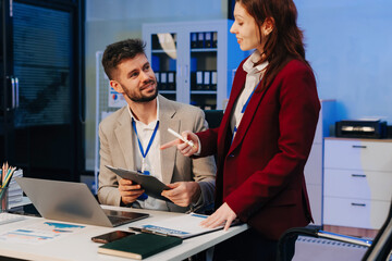 Diversity, business team working at office with laptop and documents on desk, financial adviser analyzing data, employees working overtime.