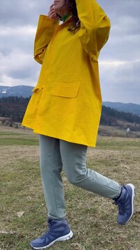 Enjoying a quiet moment in the countryside while wearing a bright yellow raincoat