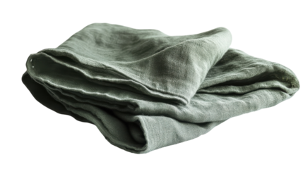 A green linen cloth gently folded on a white surface, highlighting its texture and simplicity