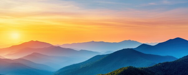 Obraz premium A stunning sunset over rolling mountains, showcasing vibrant hues of orange, blue, and purple, creating a serene and picturesque landscape.