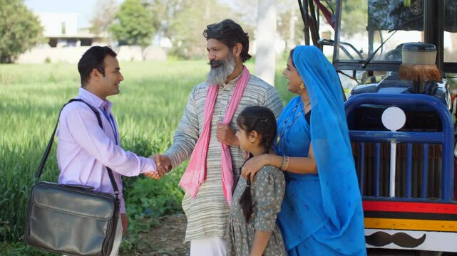 Bank employee with the old farmer's family - tractor purchase  Krishi Yojana  emergency loan  farmer loan. Indian Village man with his wife and daughter - future investments  investment  insurance ...