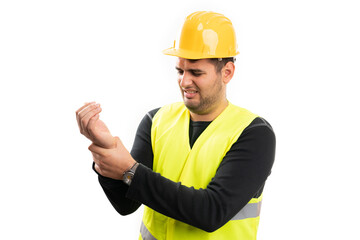 Adult builder man touching painful wrist as muscle strain at work