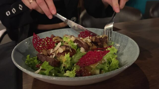 woman in the cafe, eating healthy Spicy Tremella Mushroom Salad with squid, carrot , lettuce