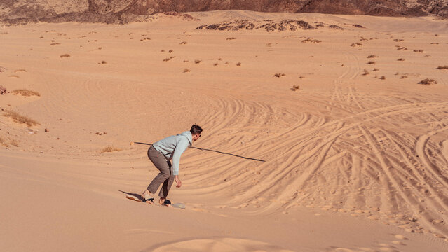 man sandboarding colored canyon in the Sinai desert in Egypt - Powered by Adobe