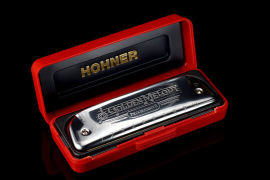 LVIV, UKRAINE - January 13, 2025: Harmonica Hohner in red case highlights musical charm