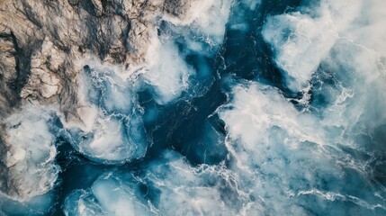 Top view of glacier with deep blue crevasses and rugged ice formations