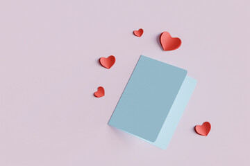 overhead view of blue paper card and red heart shaped paper cut put on pink background love wedding...