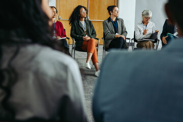 Diverse group of professionals seated in a meeting during a networking event
