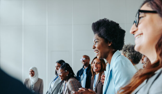 Business crowd laughing during a presentation at a conference