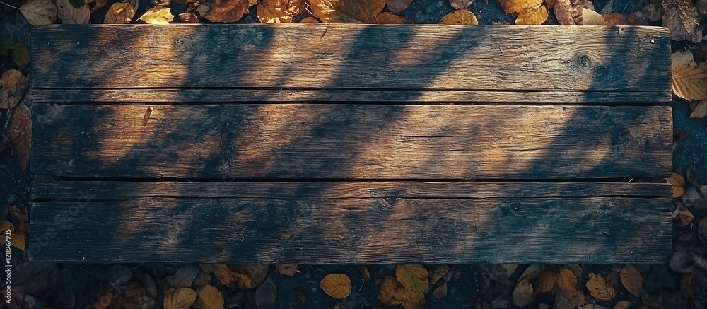 Aufkleber Wooden tabletop in autumn forest with sunlight casting shadows and colorful leaves creating an inviting space for text or design elements