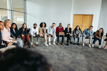 Diverse group of professionals in a circle during a collaborative discussion session