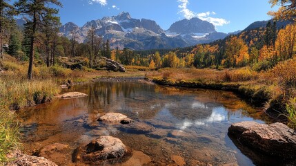 Fototapeta premium Autumnal mountain lake reflection, tranquil scene, Colorado Rockies, fall foliage. Use travel brochure