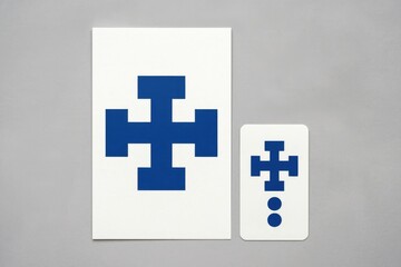 Obraz premium A simple geometric cross design printed on two cards of different sizes.