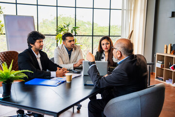 Indian asian Business professionals discussing ideas during a formal meeting in a conference room