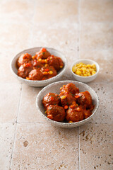 Homemade meatballs with hot sauce and corn