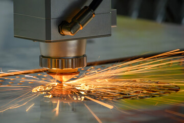 The fiber laser cutting machine  cut the metal plate with the sparkling light.