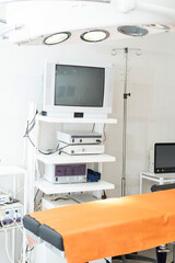 operating room, surgical equipment in the hospital, monitor for endoscopic operations, artificial respiration apparatus, modern medical equipment, operating table, lamps