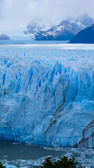 Vertical image of View of Perito Moreno Glacier with pieces of ice floating in the water, Los Glaciares National Park, Argentina