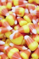 A colorful pile of candy corn sitting on a table, perfect for holidays and celebrations