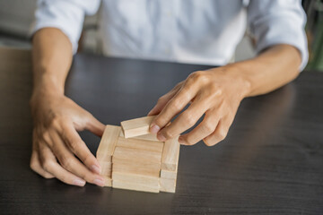 Planning risk and strategy in businessman gambling placing wooden block.Business concept for growth success process.