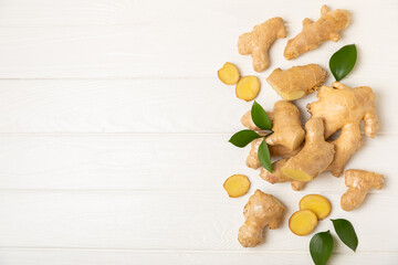Fresh ginger on wooden background. Dry ginger. Sliced ​​ginger with honey and lemon. Ginger...