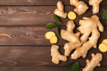 Fresh ginger on wooden background. Dry ginger. Sliced ​​ginger with honey and lemon. Ginger...