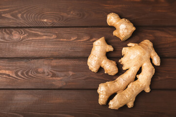 Fresh ginger on wooden background. Dry ginger. Sliced ​​ginger with honey and lemon. Ginger...