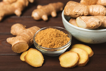 Fresh ginger on wooden background. Dry ginger. Sliced ​​ginger with honey and lemon. Ginger root. Traditional alternative medicine, healing tea for immunity. Seasoning and spices concept. Copy space.