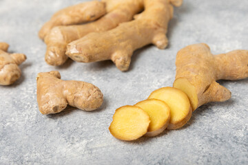 Fresh ginger on wooden background. Dry ginger. Sliced ​​ginger with honey and lemon. Ginger root. Traditional alternative medicine, healing tea for immunity. Seasoning and spices concept. Copy space.