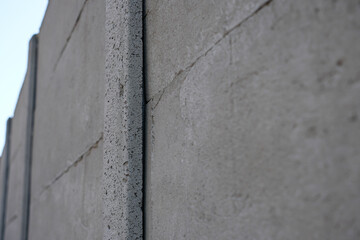 Endless concrete wall blocks the sky. Selective focus. Shallow depth of field. Copy space. 