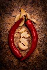 A rustic collection of red chili peppers, garlic, and dill in warm golden lighting. Close-ups and...