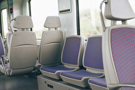 Interior view of empty modern train with patterned seats